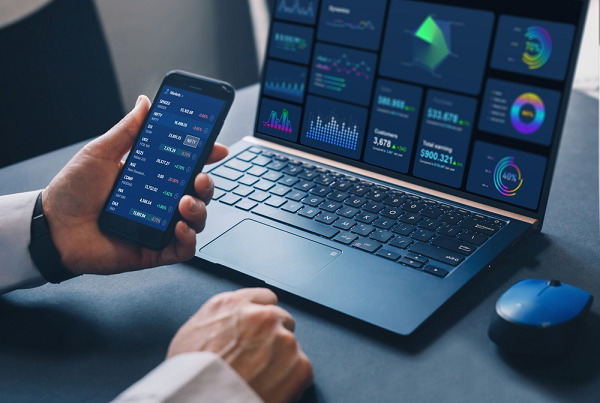 trading on laptop and phone